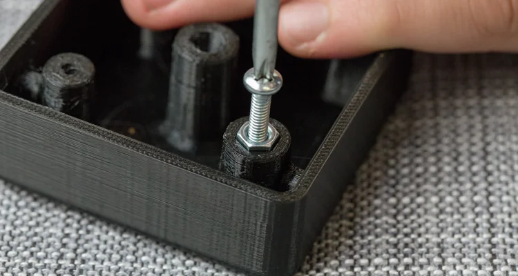 captured hex nut - Fictiv installing a screw in a 3D printed part captured nut