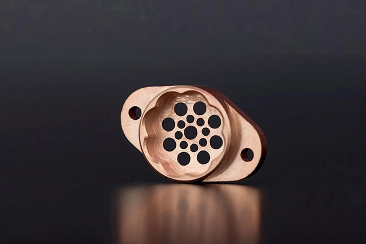 bronze - Fictiv Image of a cnc milled copper part on a black background