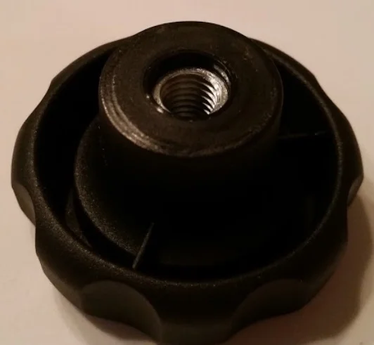 A threaded insert in a plastic knob