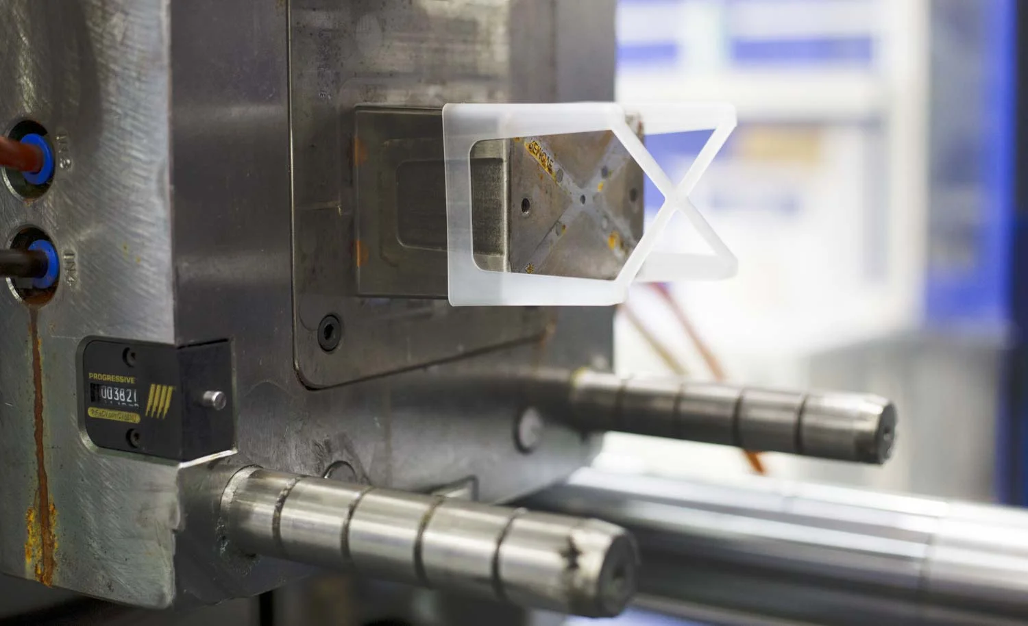 a white plastic part being ejected from an injection mold