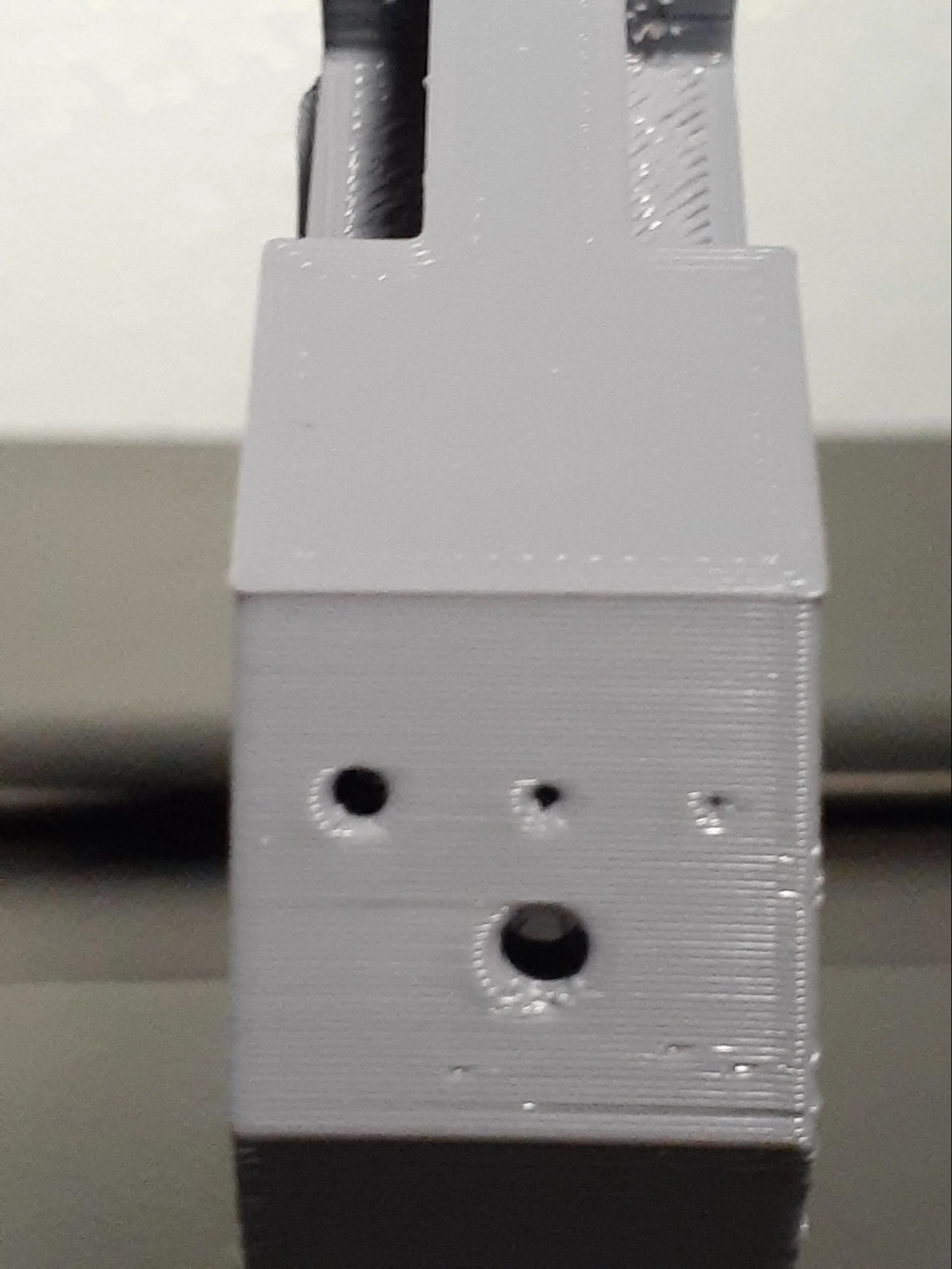 Comparing the different holes on each material from the back end of the parts.