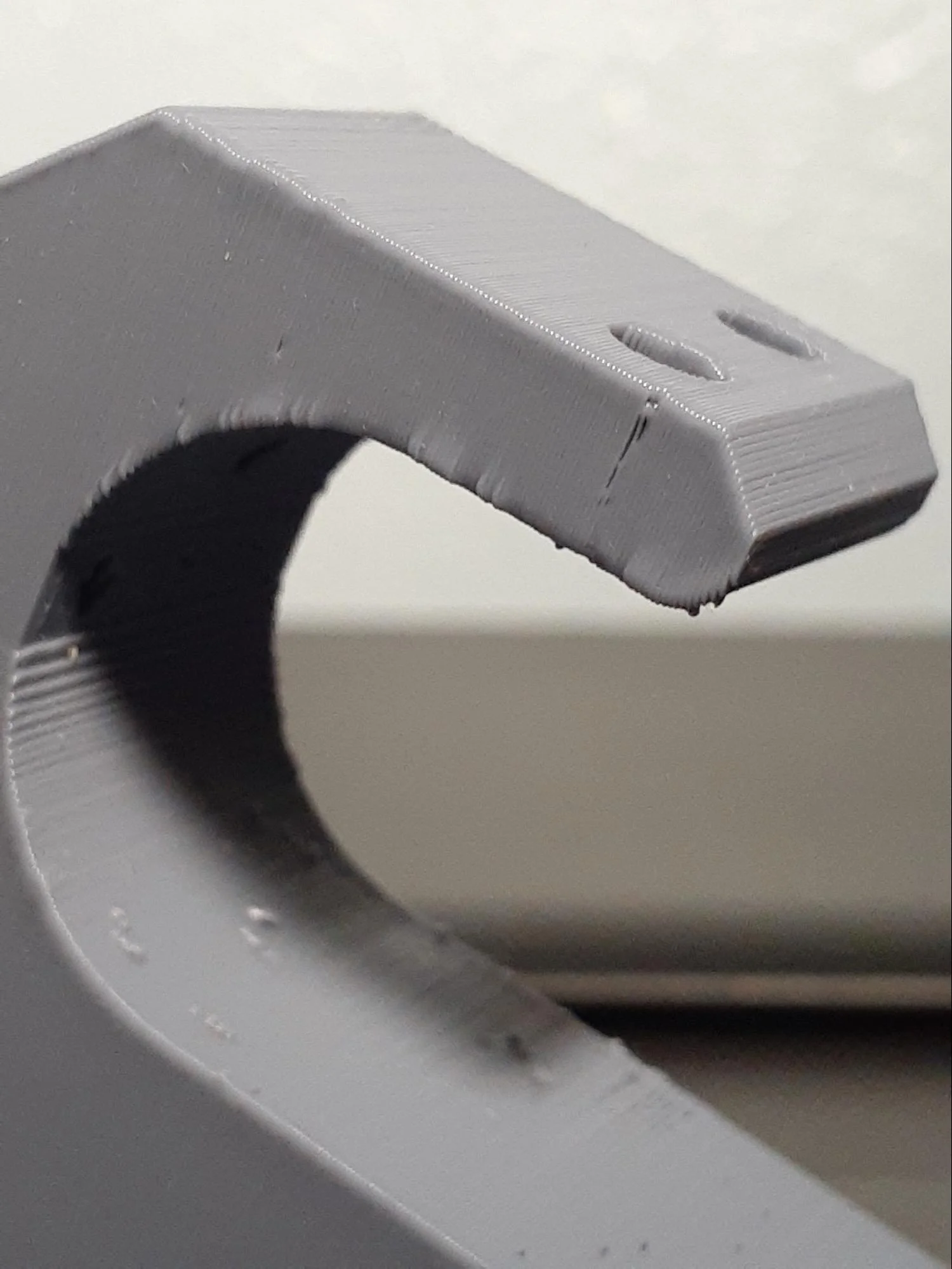 The PLA part has a rougher transition from chamfer to fillet at the common edge