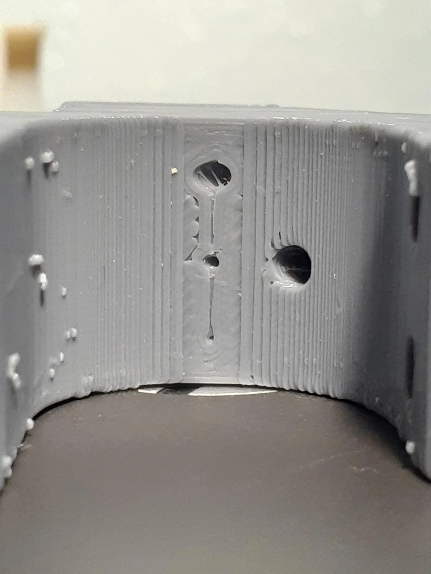 Comparing the different holes on each material from the front along the part’s hidden curved surface