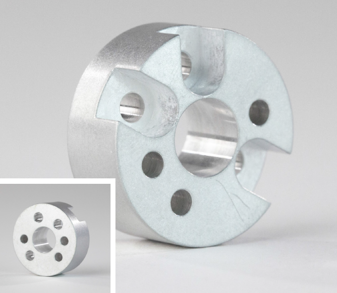 Basic of Finishing CNC Machined Parts 13 A circular metal part with holes drilled in it, finished using tumbling
