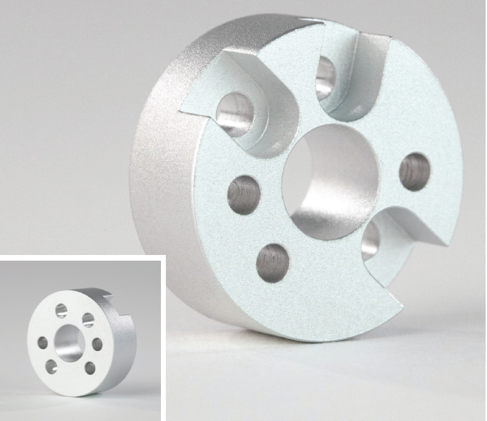 Basic of Finishing CNC Machined Parts 12 A circular metal part with holes drilled in it, finished using media blasting