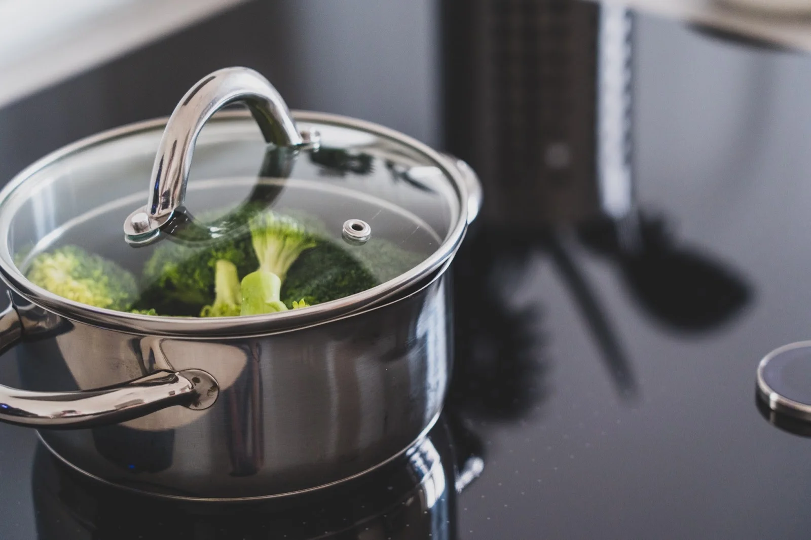 stainless steel pot with broccoli on stove