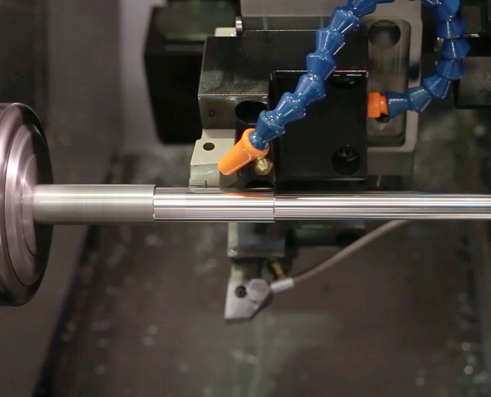 metal rod being turned on a lathe with air coolant feed