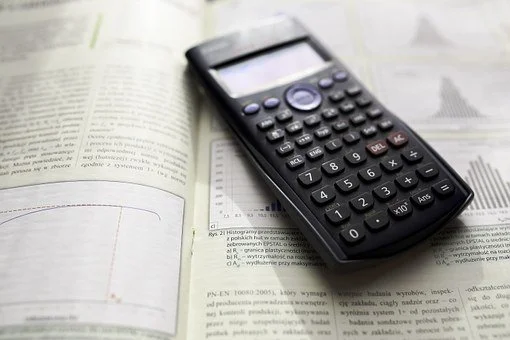 calculator - Fictiv a scientific calculator sitting on top of an open statistics textbook