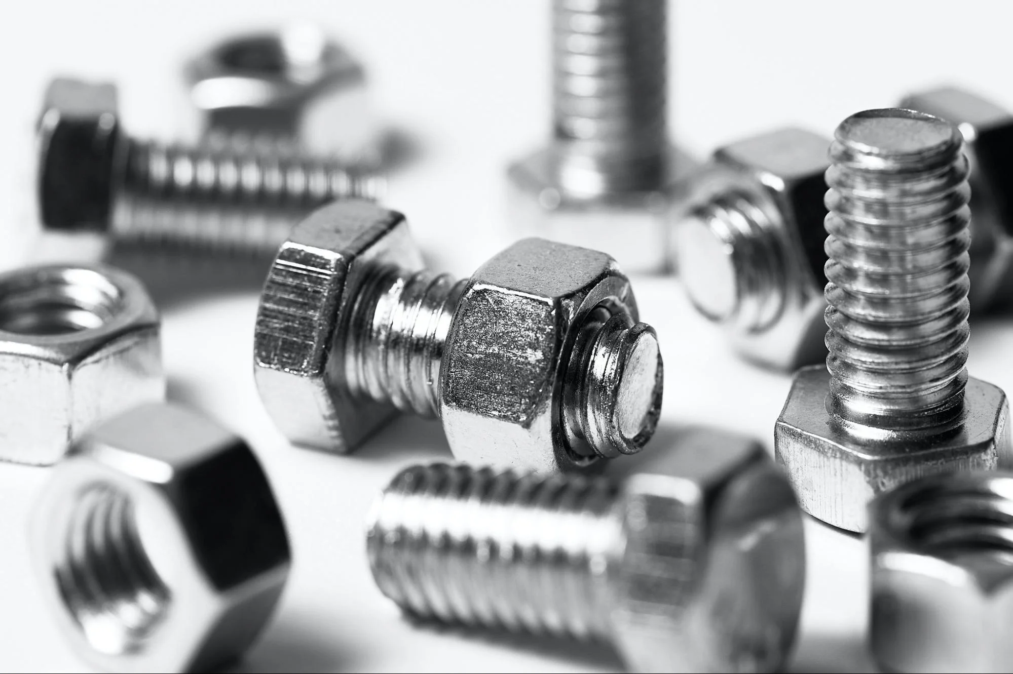 nuts and bolts - Fictiv shiny nuts and bolts with white background