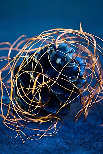 fictiv1image2 - Fictiv Image of thin copper wire and blue pinecone artwork on a blue background