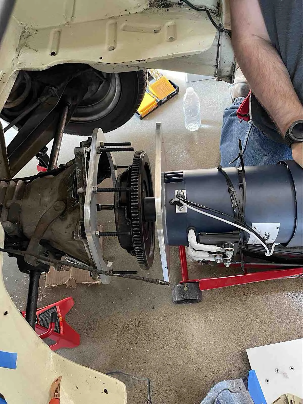 fictiv1image1 - Fictiv image of electric motor, aluminum mounting plate and flywheel being attached to the drivetrain of a 1966 fiat 500