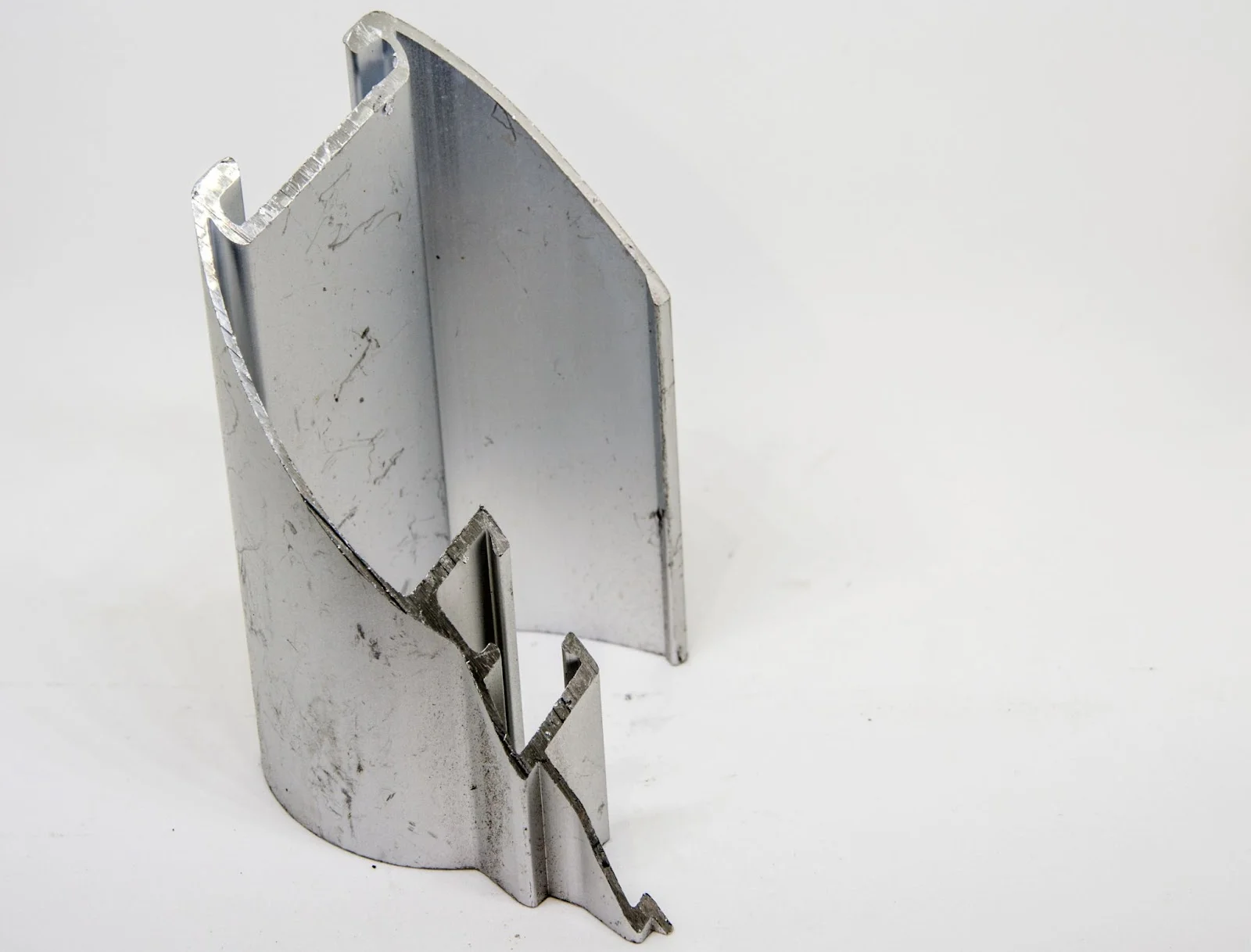 A-piece-of-scrap-6063-aluminum - Fictiv A piece of scrap 6063 aluminum extruded metal; shows formability