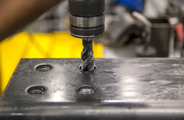 tapping-a-hole-in-a-metal-part- - Fictiv tapping a hole in a metal part