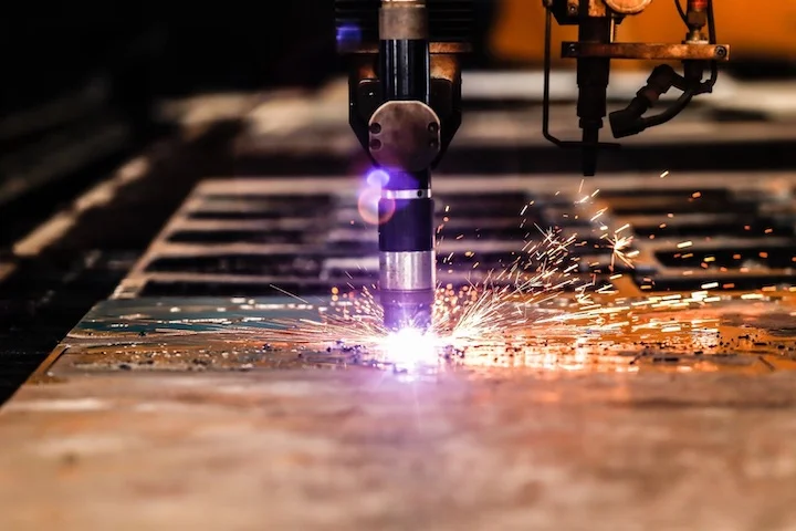 A CNC plasma cutter cuts parts out of steel sheet stock