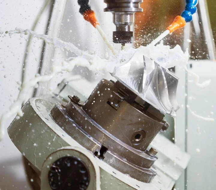 Coolant being sprayed - Fictiv coolant sprayed on an impeller during precision CNC machining