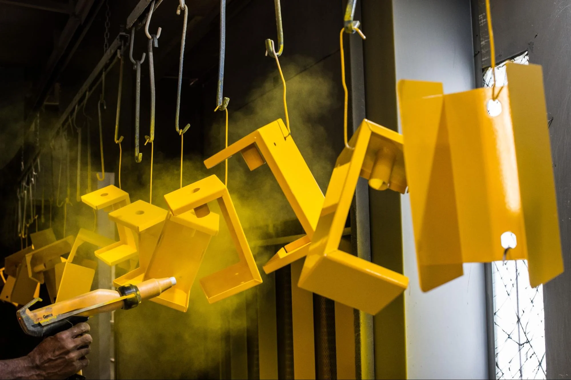 powder coating process sheet metal - Fictiv Sheet metal parts being powder-coated.