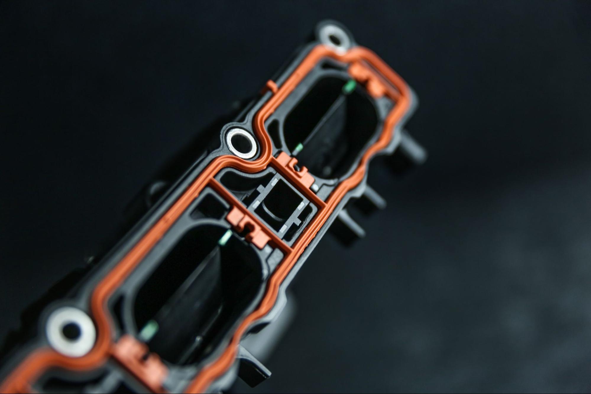 An intake manifold with insert molded parts.