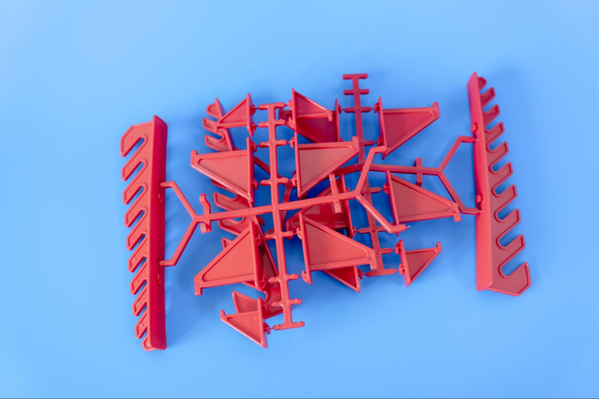 Injection-molded parts with runners attached.
