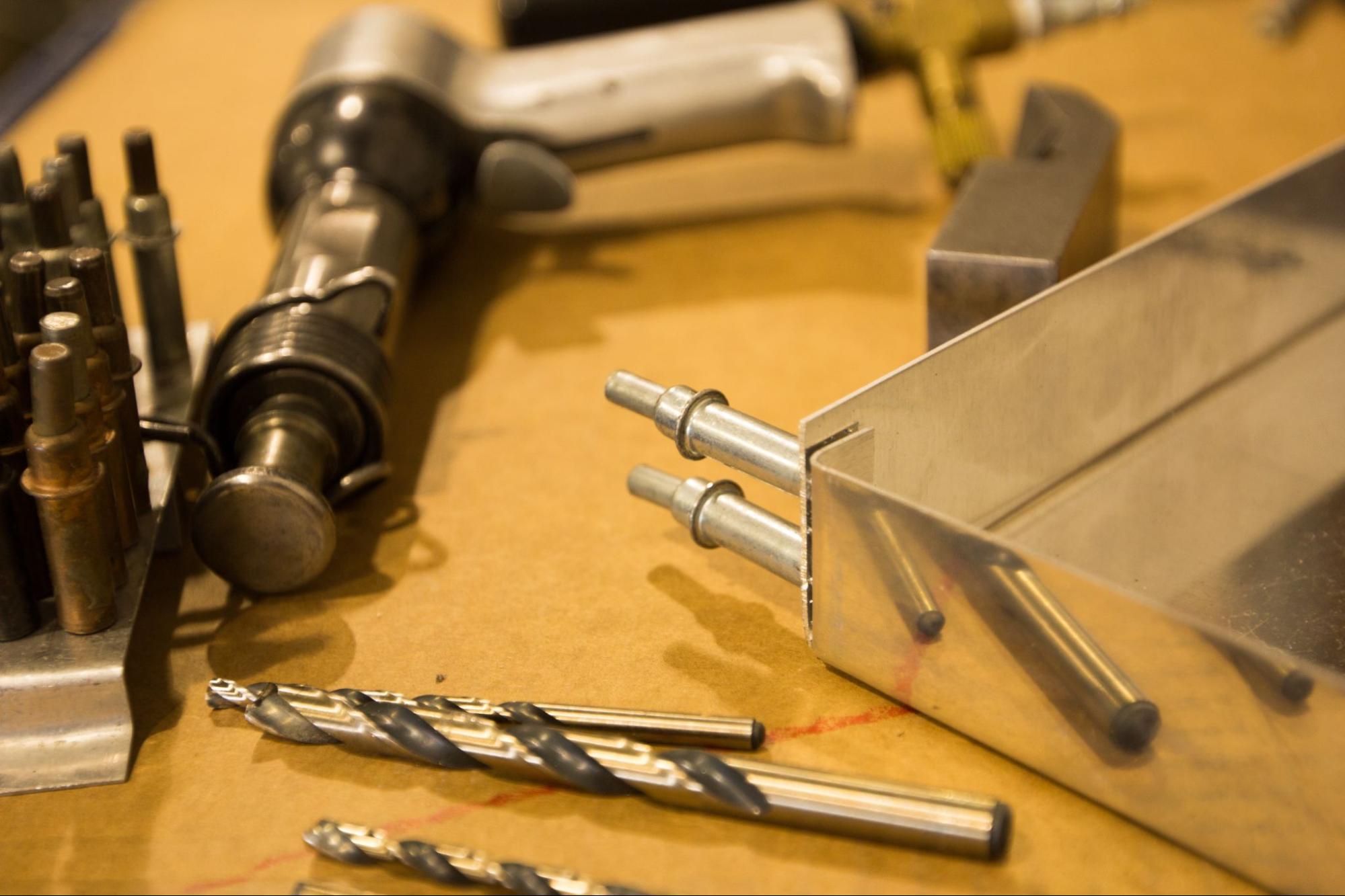 Cleco pins hold the corner of a sheet metal assembly in place