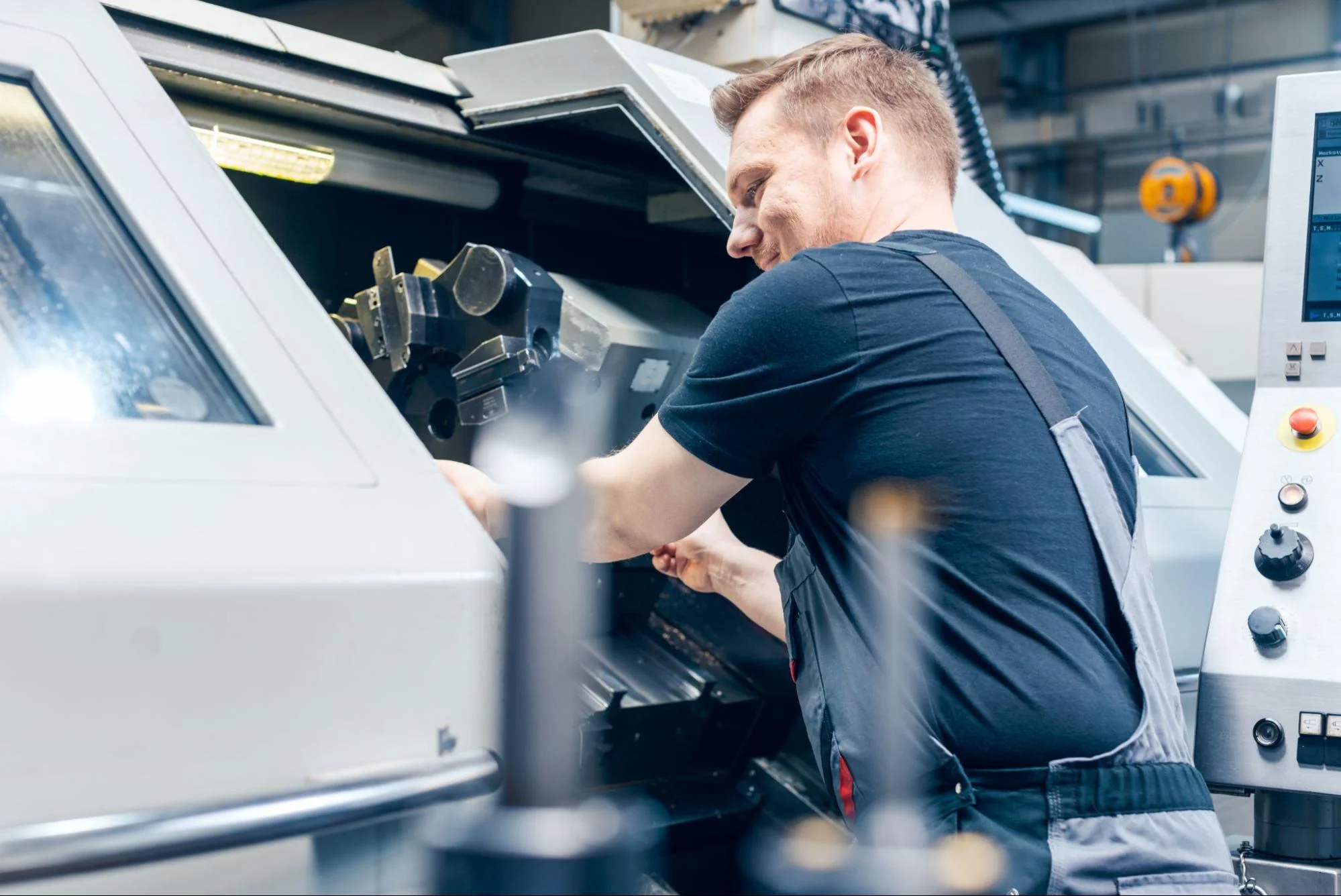 Machinist operating a CNC machine.