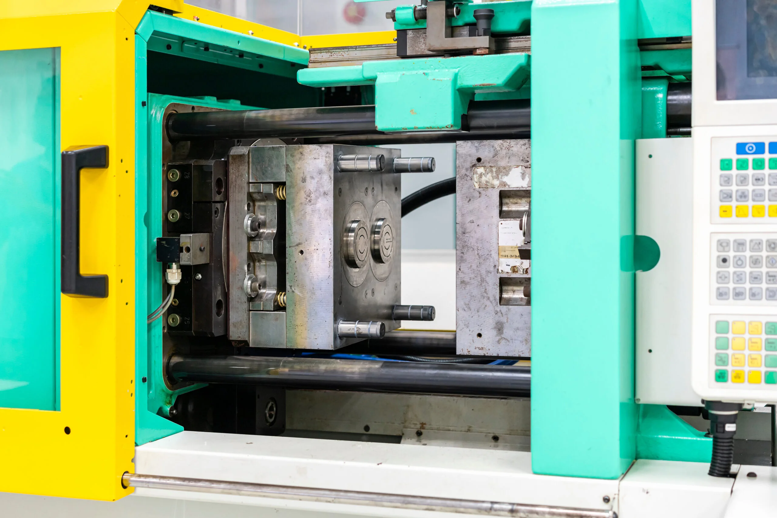 metal mould or plastic injection mold setup on high pressure injection molding machine for mass production or manufacturing in industrial - Fictiv Alt text: Conventional injection molding machine.