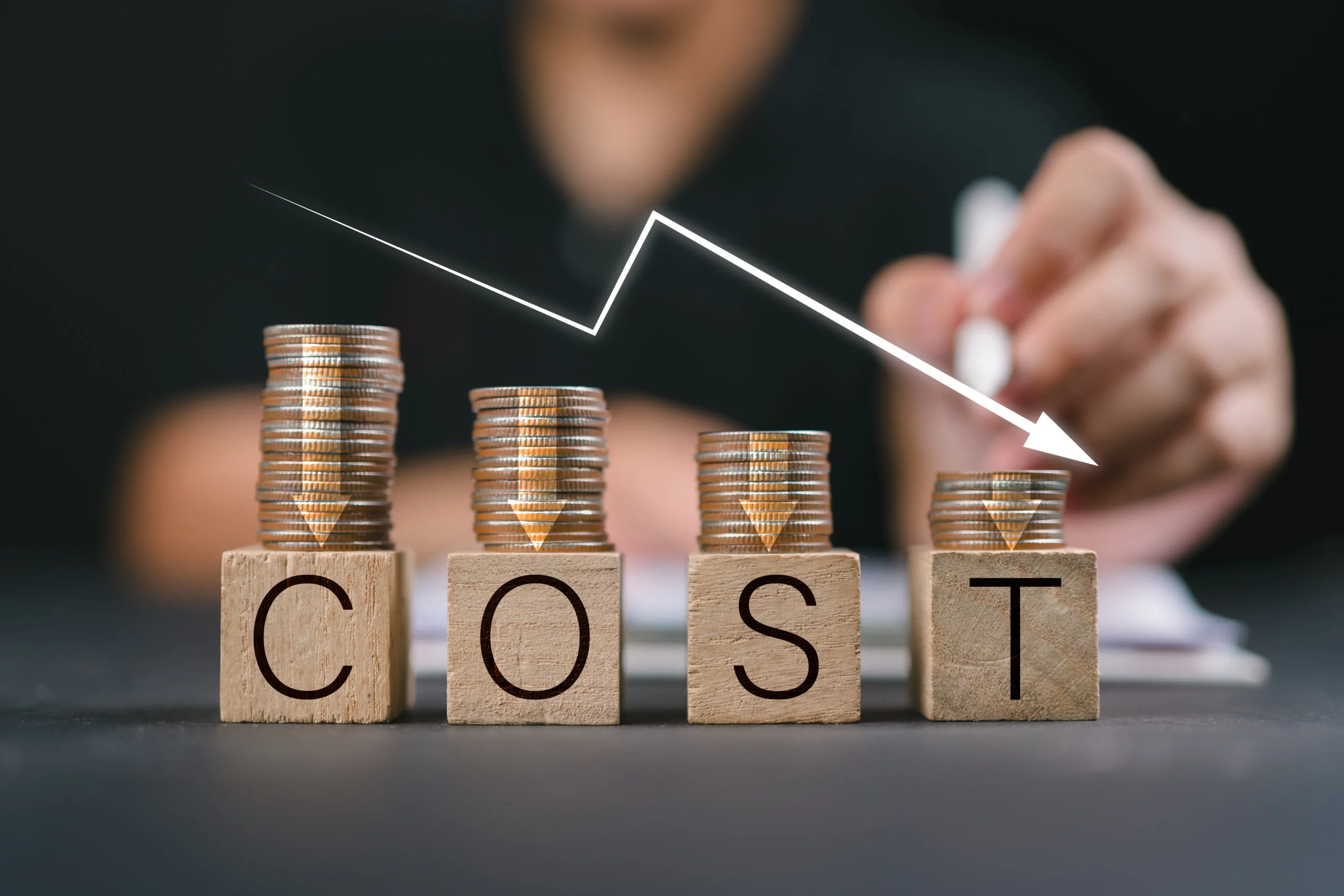 Cost reduction concept Cost wording on decreasing coins stacking with the down arrow Businessman working on company cost saving Cost Management Economy recession low budget Effective business - Fictiv prototyping cost price