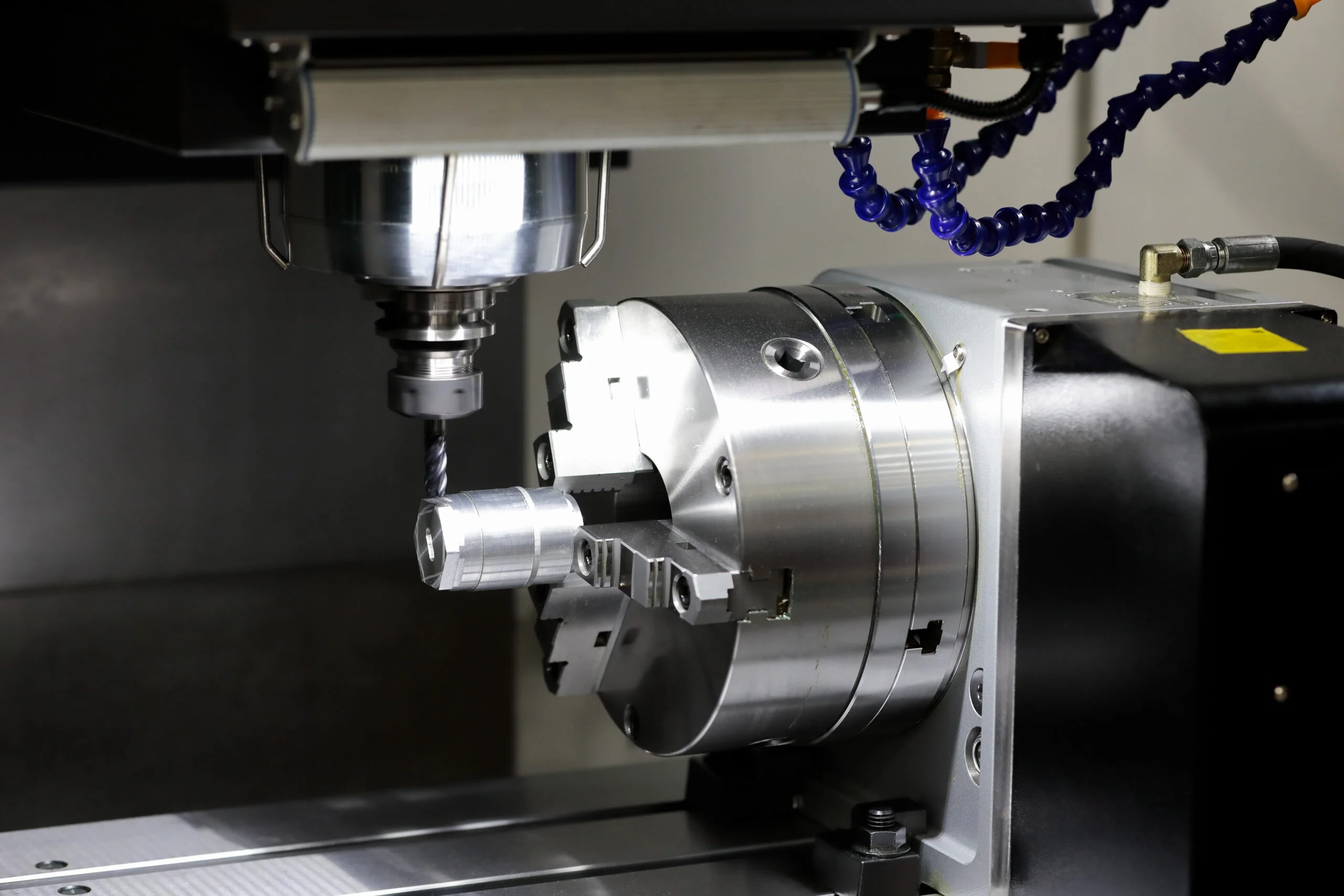 4-AxisCNC machine spindle with a cutting tool.