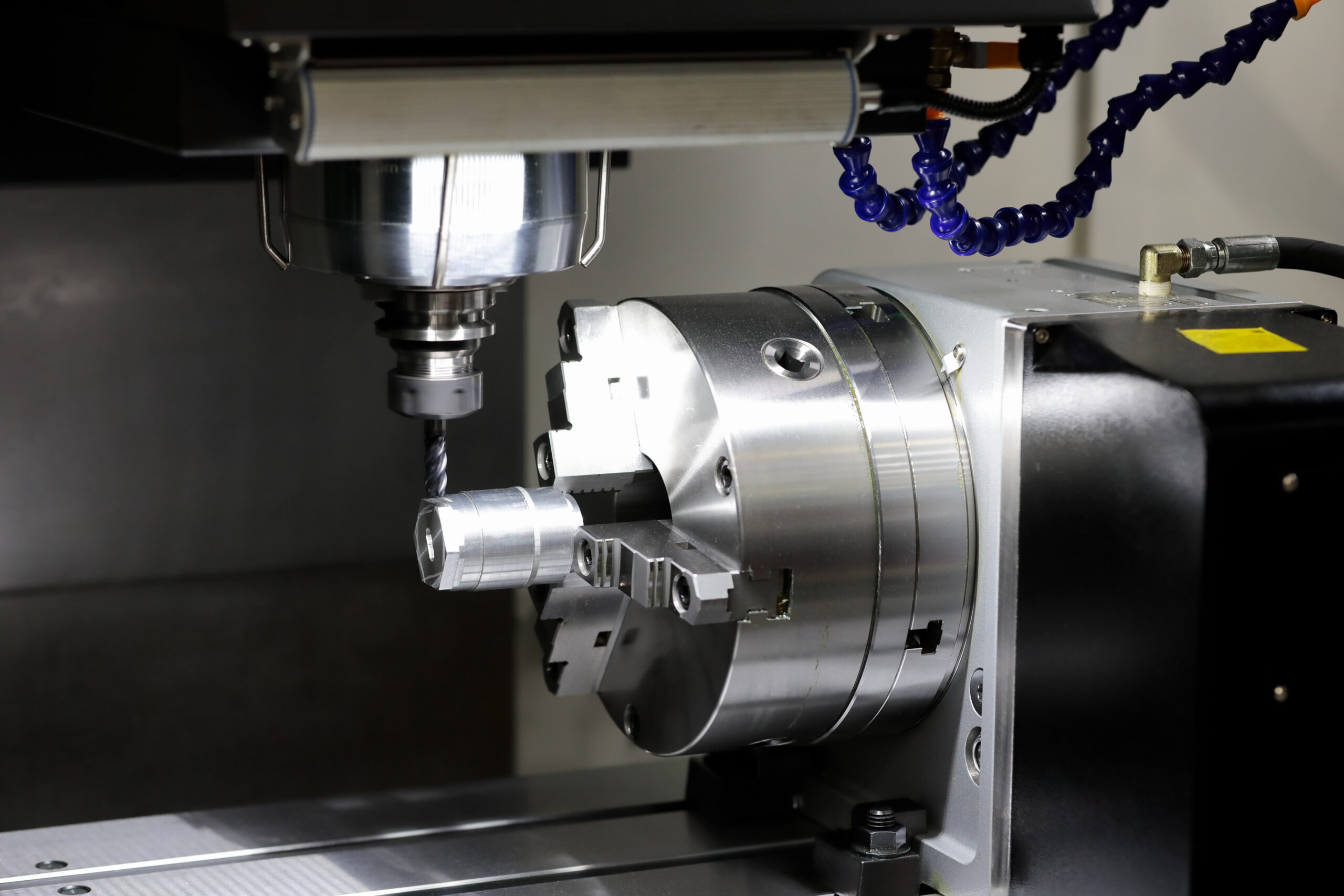 4-AxisCNC machine spindle with a cutting tool.