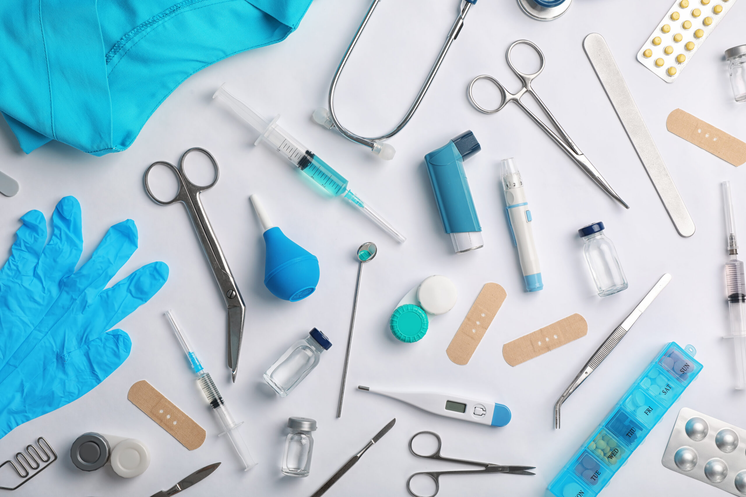 Many different medical objects on light background flat lay - Fictiv Manufacturing medical devices