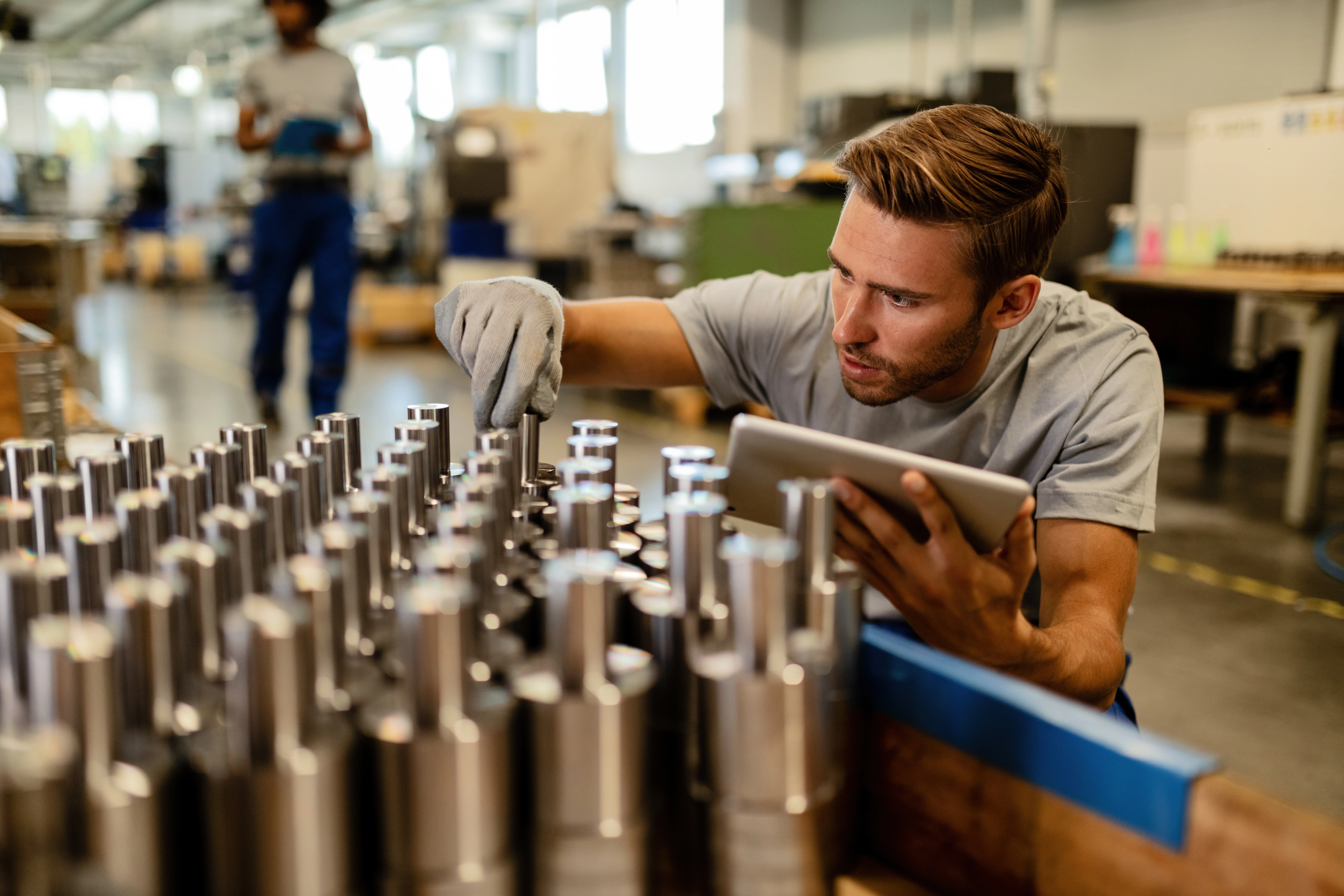 Worker performing quality control of manufactured pilot run