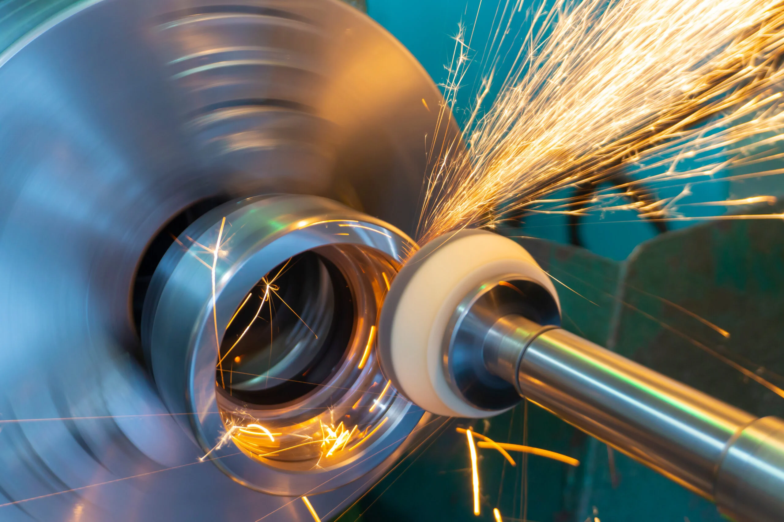 End processing of a metal surface with an abrasive stone on a circular grinding machine sparks fly in different directions - Fictiv Rotational grinding a metal part with sparks flying