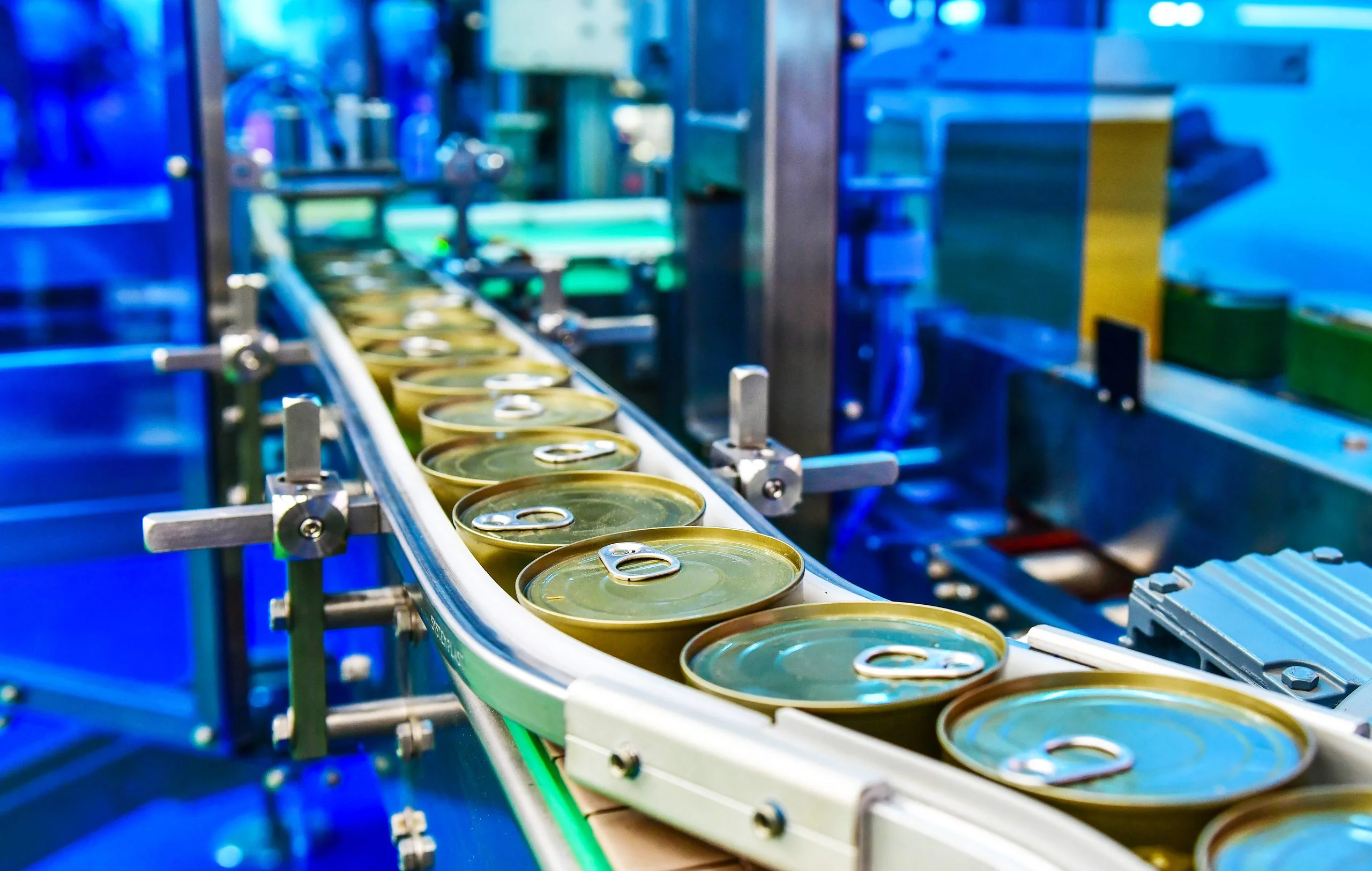 Canned food products on conveyor belt in distribution warehouseparcels transportation system concept - Fictiv Food packaging assembly line