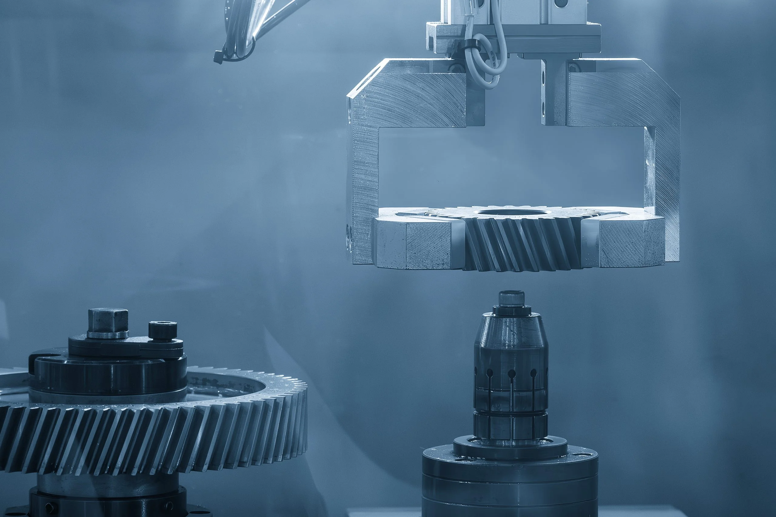 Custom machined jaw grippers placing a gear component